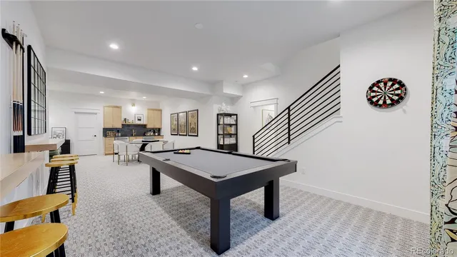 a room with furniture pool table and a rug