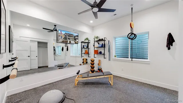 a living room with furniture gym equipment and a window