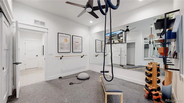 a view of a livingroom with furniture and a ceiling fan