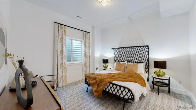 a bedroom with a bed a dresser and a window