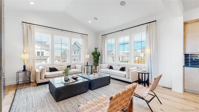 a living room with furniture and large windows