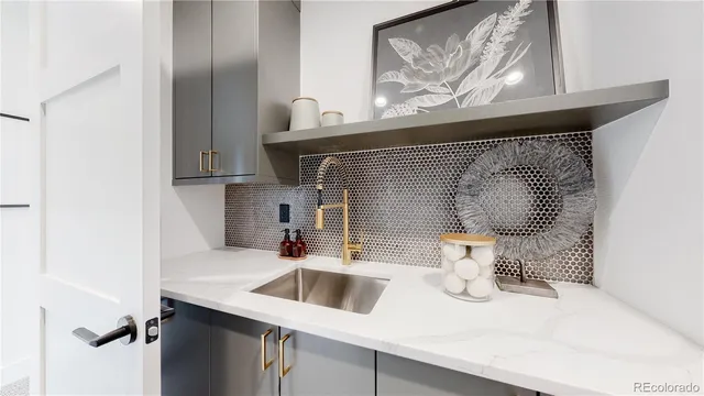 a kitchen with a sink and a stove top oven