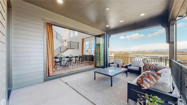 a living room with furniture and a floor to ceiling window
