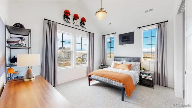 a bedroom with a bed and a large window