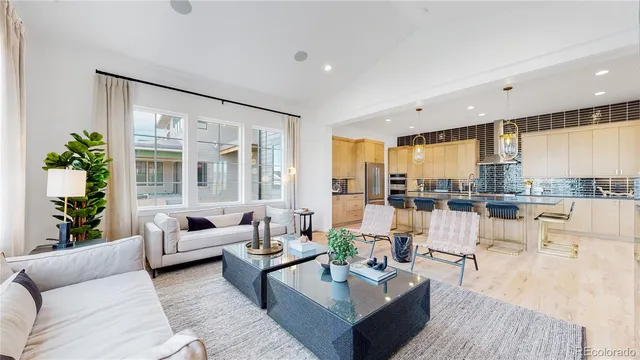 a living room with furniture and large windows