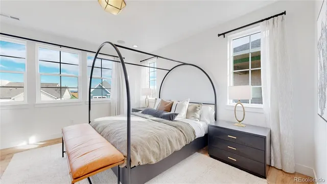 a bedroom with a bed and a large window