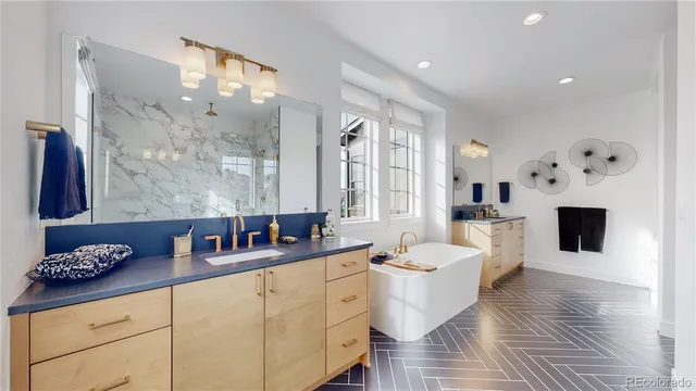 a bathroom with a granite countertop sink mirror bathtub shower and toilet