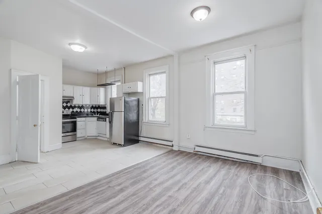 a kitchen with stainless steel appliances a refrigerator and a stove top oven