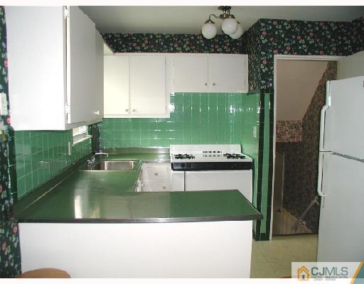 188 North Hill Road Colonia, NJ 07067 - Photo 4 of 10 a kitchen with a refrigerator a stove and a microwave