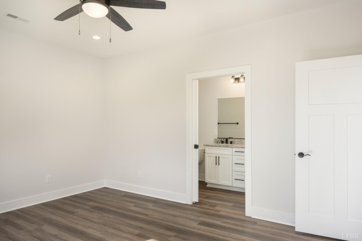 125 Lockridge Lane Lynchburg, VA 24502 - Photo 15 of 28 an empty room with wooden floor cabinet and windows