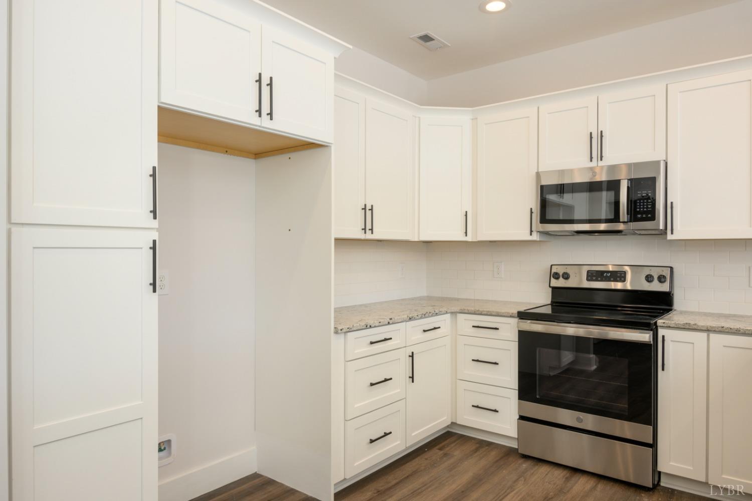125 Lockridge Lane Lynchburg, VA 24502 - Photo 4 of 28 a kitchen with white cabinets and stainless steel appliances