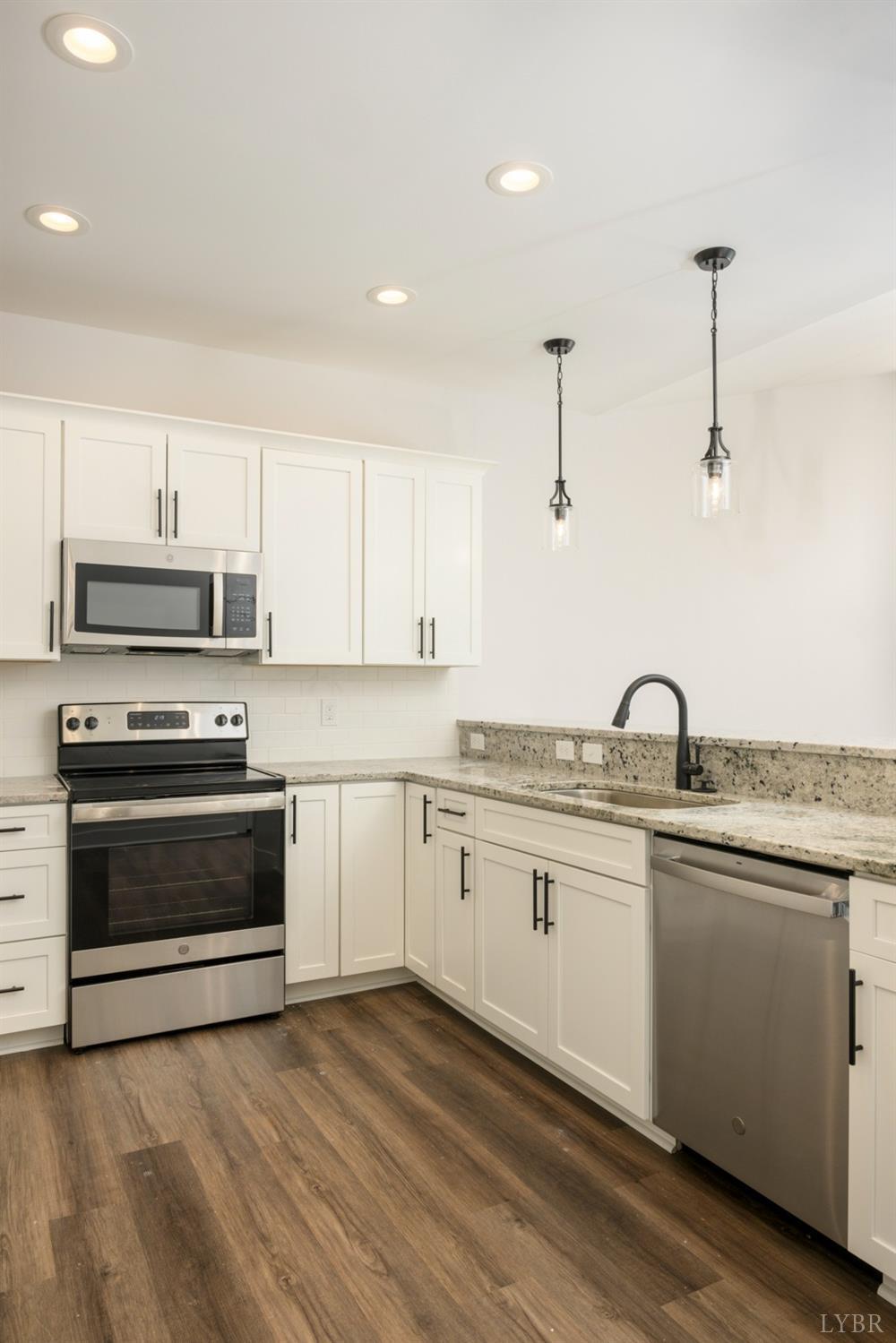 125 Lockridge Lane Lynchburg, VA 24502 - Photo 6 of 28 a kitchen with granite countertop a sink stainless steel appliances and white cabinets