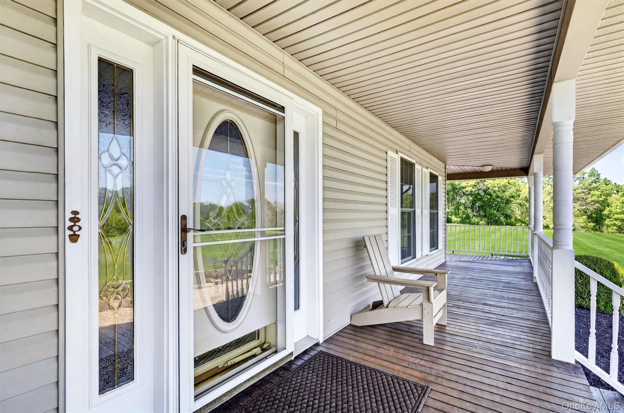 954 Ridgebury Road New Hampton, NY 10958 - Photo 7 of 45 A closer look at the front entry shows the home’s inviting character, with detailed glass doors, a covered porch, and a comfortable spot to sit and unwind.