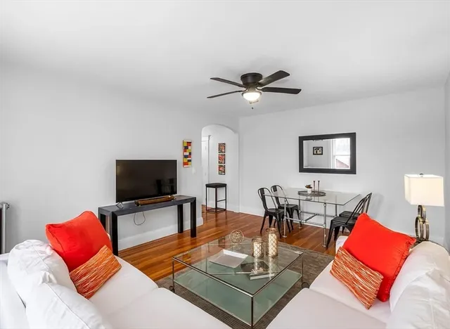a living room with furniture a dining table and a flat screen tv