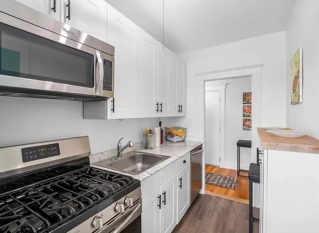 a kitchen with stainless steel appliances granite countertop a stove and a microwave