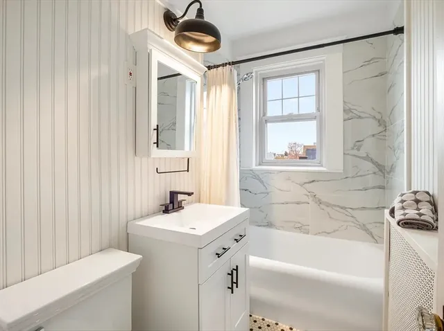 a bathroom with a sink a bathtub and a shower