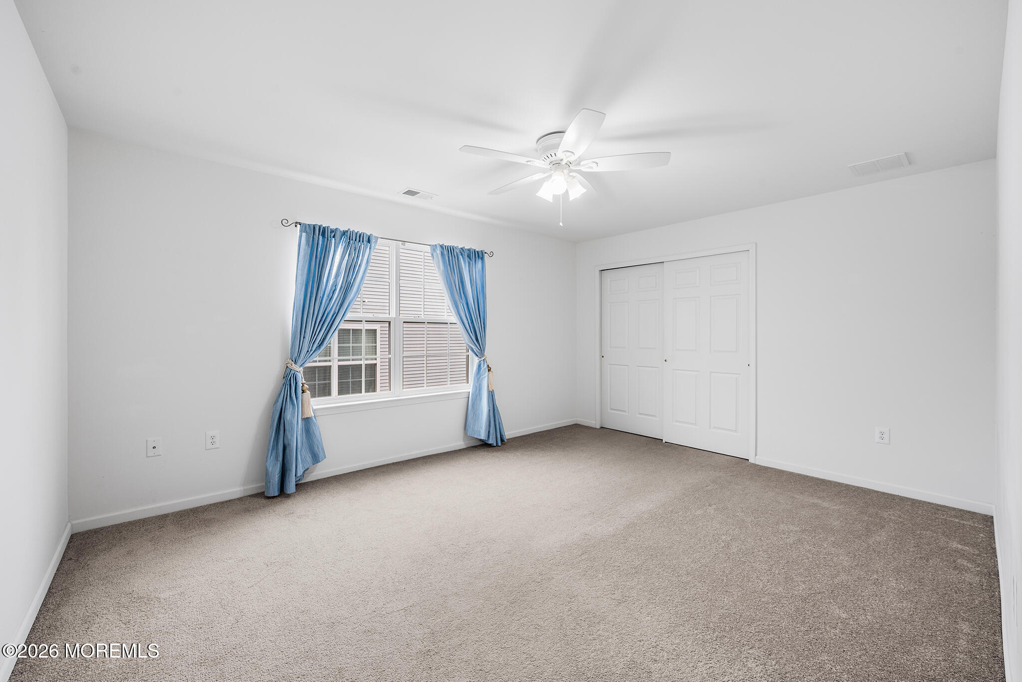 7 Brattleboro Road Jackson, NJ 08527 - Photo 34 of 62 an empty room with a ceiling fan and window
