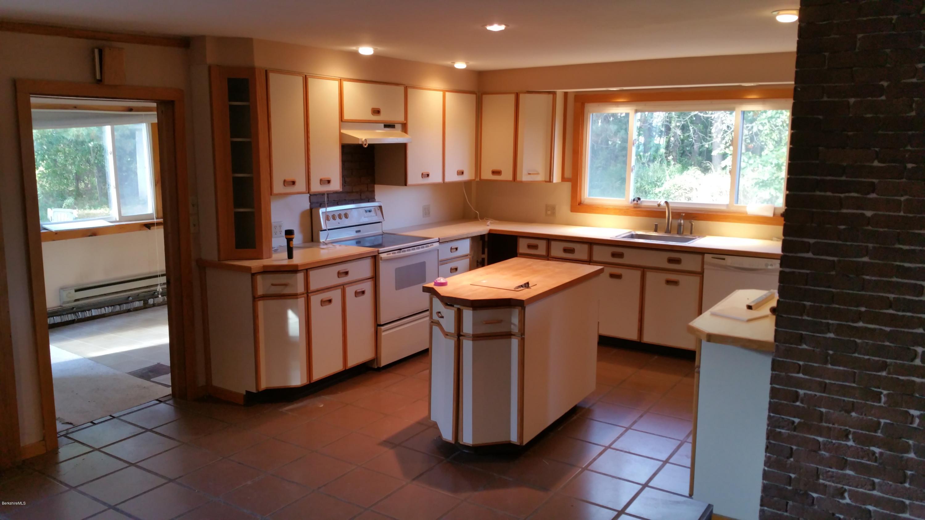 198 State Road Richmond, MA 01201 - Photo 8 of 27 a kitchen with a sink stove and cabinets