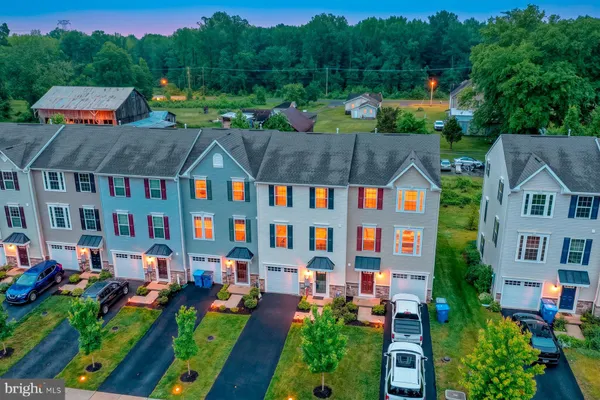 an aerial view of multiple houses with yard