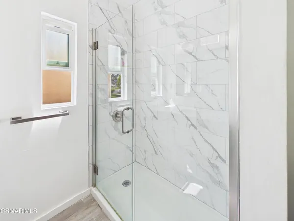 a bathroom with a glass shower door