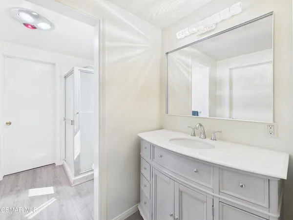 a bathroom with a sink vanity and a mirror