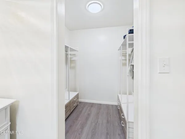 a view of hallway with wooden floor