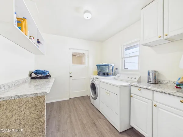 a utility room with sink dryer and washer