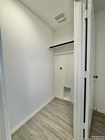 a view of hallway with wooden floor