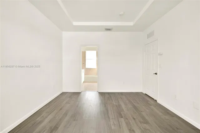 a view of a room with wooden floor