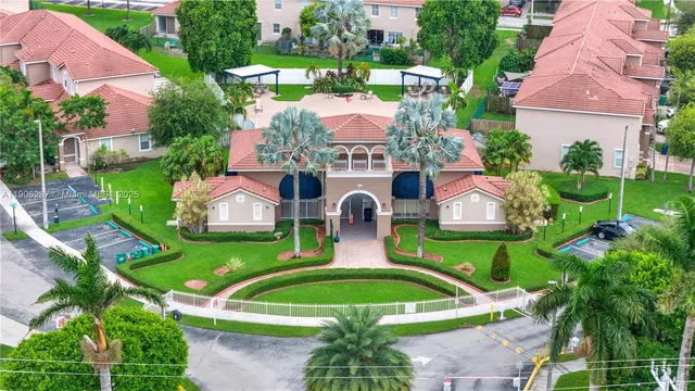 an aerial view of a house with a garden and swimming pool