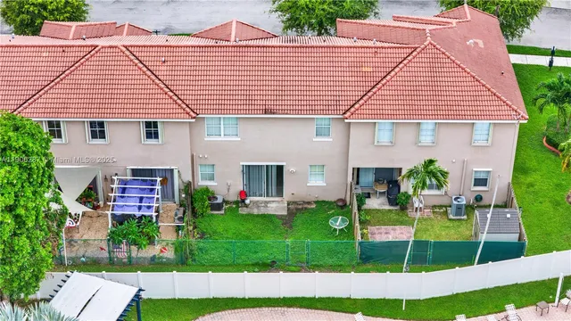 a front view of a house with a garden and plants