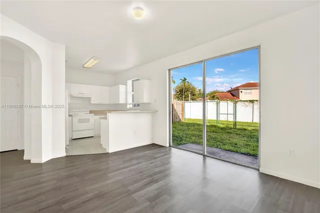 a view of a kitchen with wooden floor and a kitchen