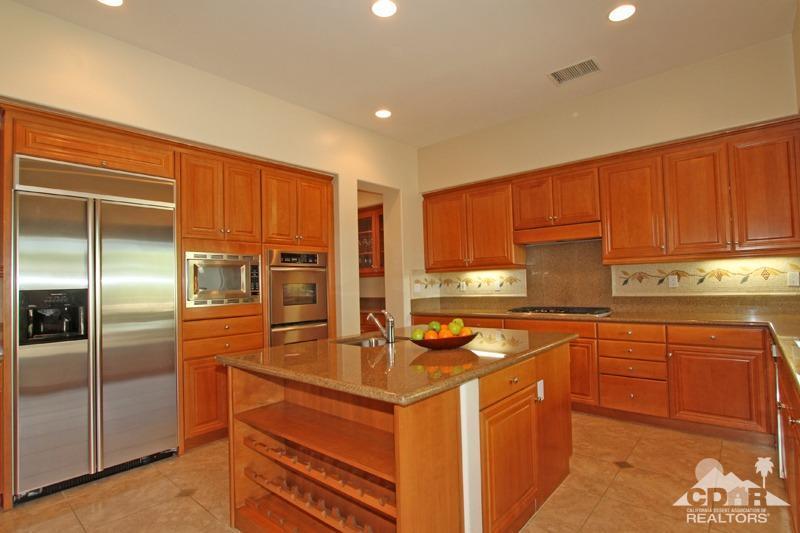 346 Loch Lomond Road Rancho Mirage, CA 92270 - Photo 12 of 34 a kitchen with stainless steel appliances granite countertop a sink a stove and a refrigerator