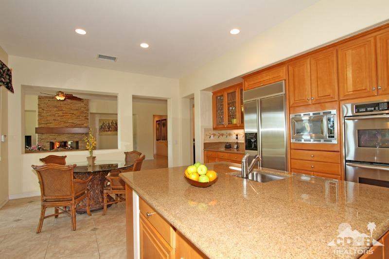 346 Loch Lomond Road Rancho Mirage, CA 92270 - Photo 13 of 34 a kitchen with a table chairs and flat screen tv