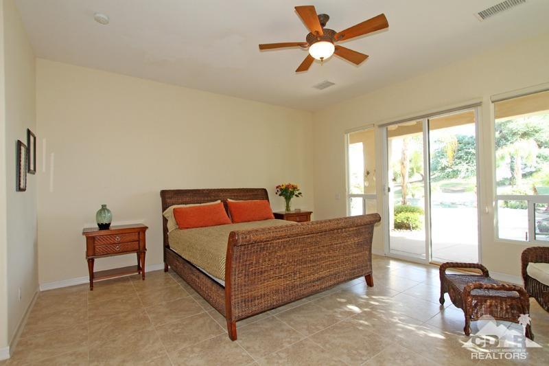 346 Loch Lomond Road Rancho Mirage, CA 92270 - Photo 18 of 34 a bedroom with a bed and a chandelier