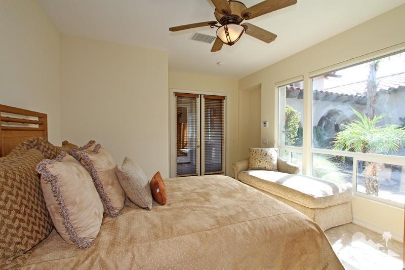 346 Loch Lomond Road Rancho Mirage, CA 92270 - Photo 22 of 34 a bedroom with a large bed and a window