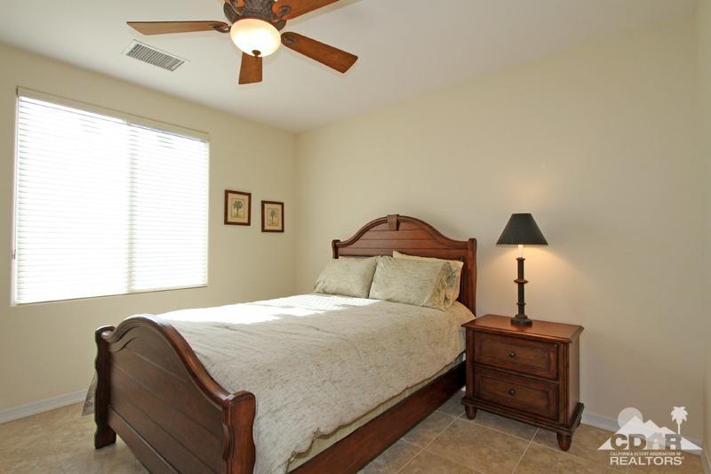 346 Loch Lomond Road Rancho Mirage, CA 92270 - Photo 24 of 34 a bedroom with a bed and a chandelier