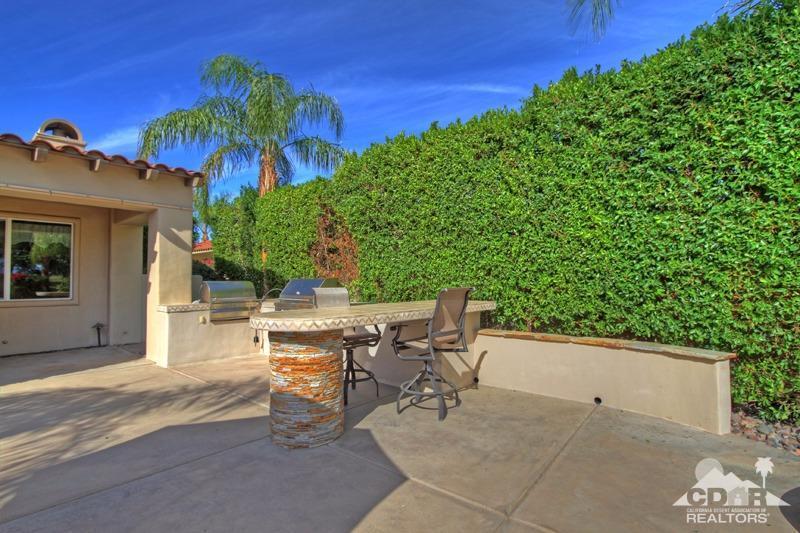 346 Loch Lomond Road Rancho Mirage, CA 92270 - Photo 27 of 34 a view of a patio with a table and chairs under an umbrella