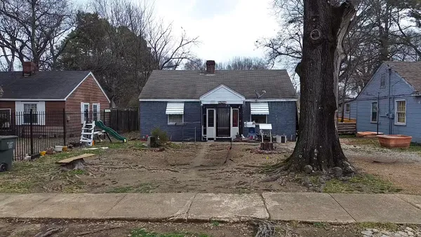 a front view of a house with a yard