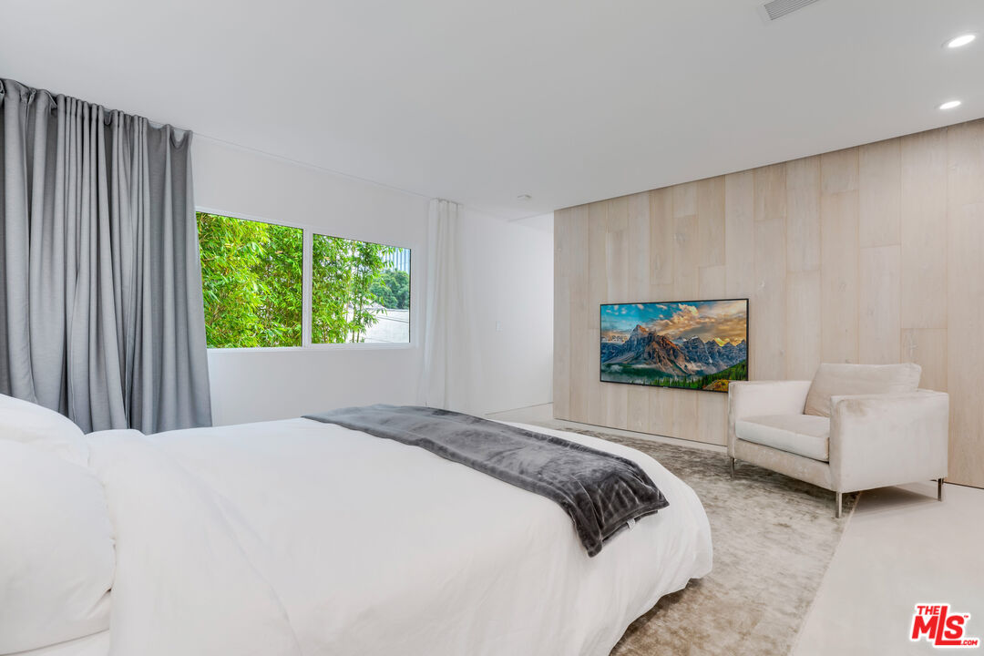 Undisclosed Address Los Angeles, CA 90064 - Photo 19 of 25 a bedroom with a bed a couch and a window