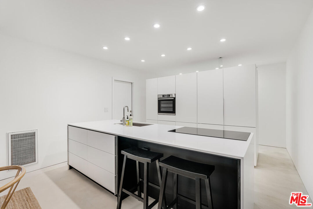 Undisclosed Address Los Angeles, CA 90064 - Photo 3 of 25 a kitchen with a sink stainless steel appliances and white cabinets