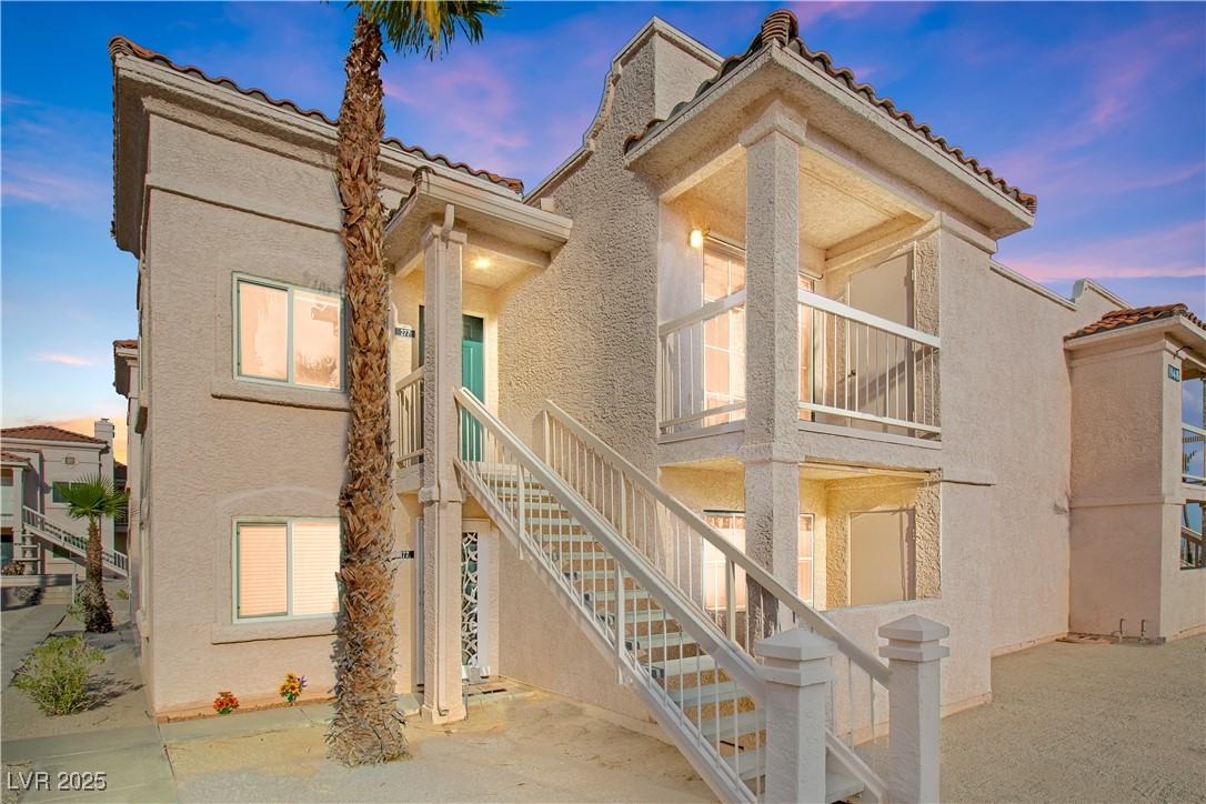 1948 Las Palmas Lane, Unit 277 Laughlin, NV 89029 - Photo 1 of 71 View of front facade with stucco siding, a tile roof, a patio area, and stairway to the 2nd floor home