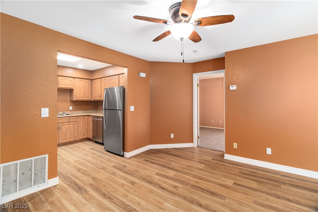 1948 Las Palmas Lane, Unit 277 Laughlin, NV 89029 - Photo 11 of 71 Dining area leads into the Kitchen with appliances with stainless steel finishes, ceiling fan, light wood-style floors, light brown cabinets, and light countertops