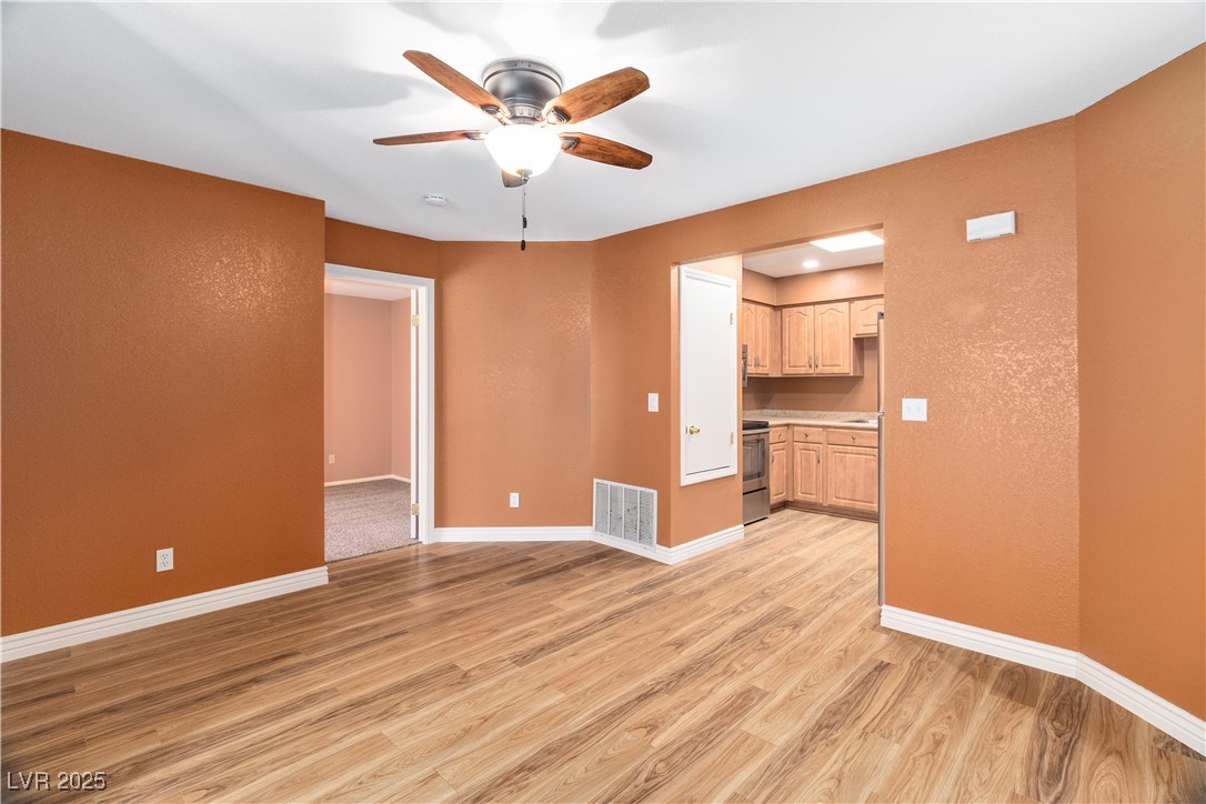 1948 Las Palmas Lane, Unit 277 Laughlin, NV 89029 - Photo 12 of 71 Dining area leads into the Kitchen with appliances with stainless steel finishes, ceiling fan, light wood-style floors, light brown cabinets, and light countertops