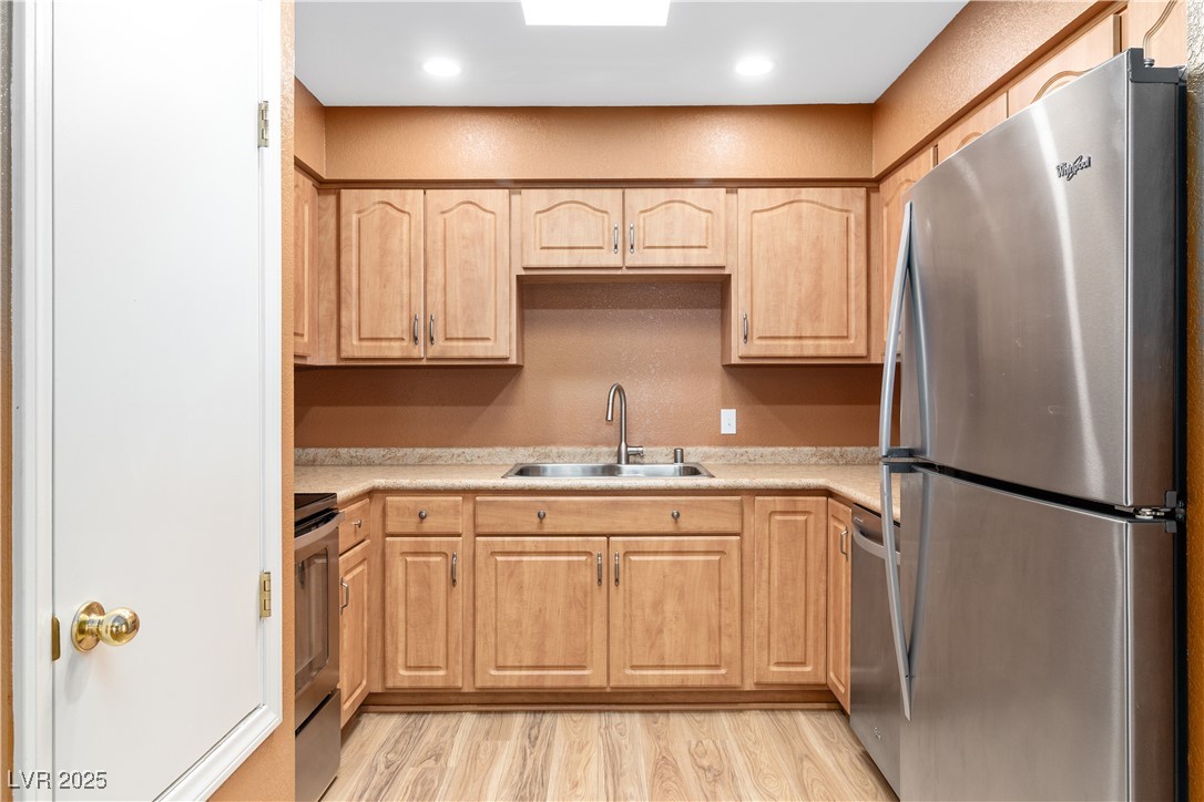 1948 Las Palmas Lane, Unit 277 Laughlin, NV 89029 - Photo 13 of 71 Kitchen featuring stainless steel appliances, light brown cabinets, light countertops, and light wood-style flooring