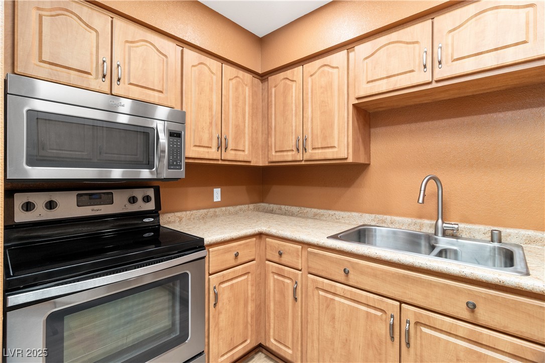 1948 Las Palmas Lane, Unit 277 Laughlin, NV 89029 - Photo 14 of 71 Kitchen with appliances with stainless steel finishes, light brown cabinets, and light countertops