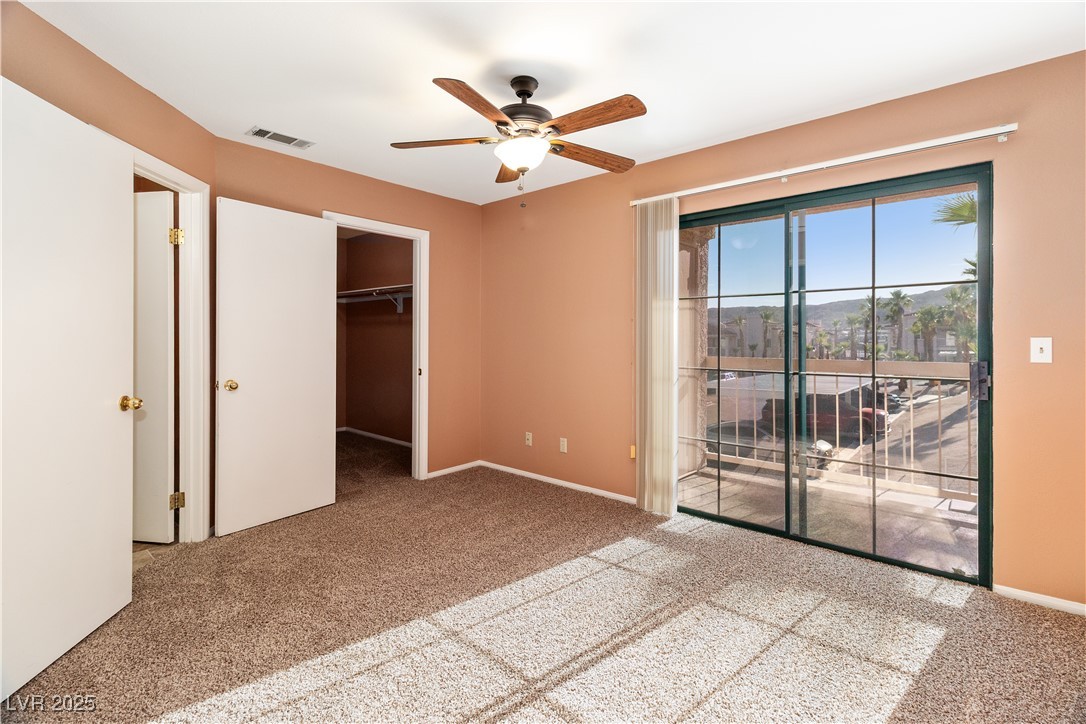 1948 Las Palmas Lane, Unit 277 Laughlin, NV 89029 - Photo 18 of 71 Unfurnished bedroom with carpet flooring, access to outside, a ceiling fan, and a walk in closet