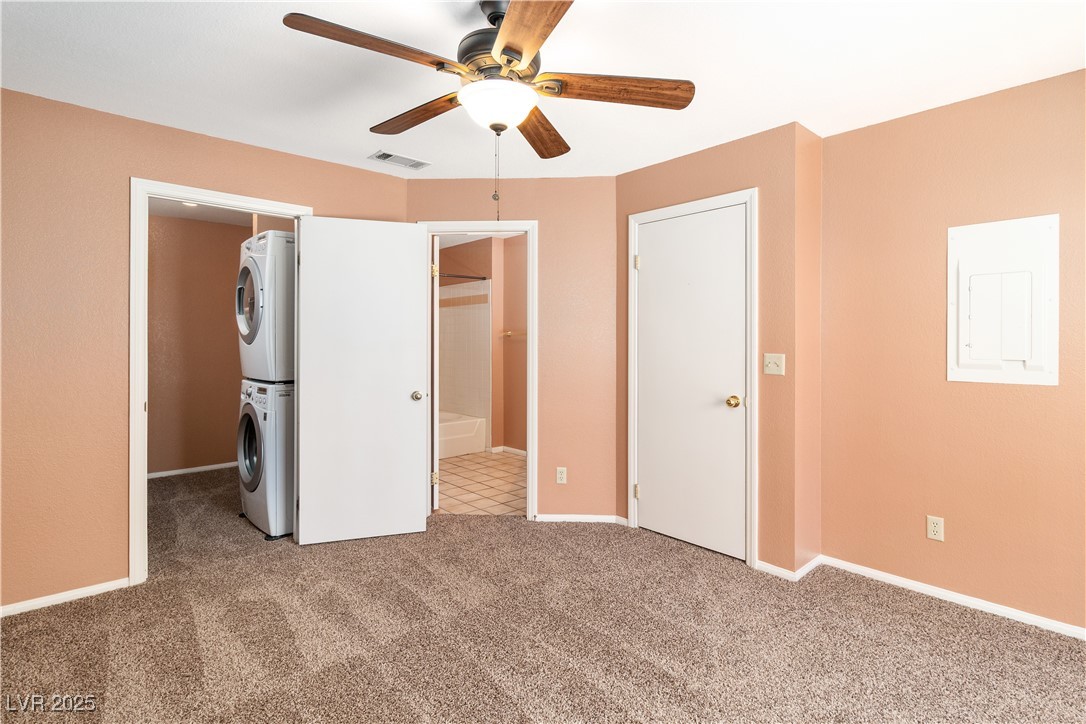 1948 Las Palmas Lane, Unit 277 Laughlin, NV 89029 - Photo 33 of 71 Second Bedroom featuring stacked washer / dryer, carpet floors, a walk in closet, ensuite bathroom, and a ceiling fan