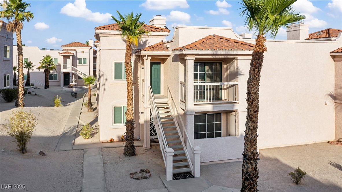 1948 Las Palmas Lane, Unit 277 Laughlin, NV 89029 - Photo 50 of 71 View of front of house with stucco siding, stairway, a tiled roof, and a chimney