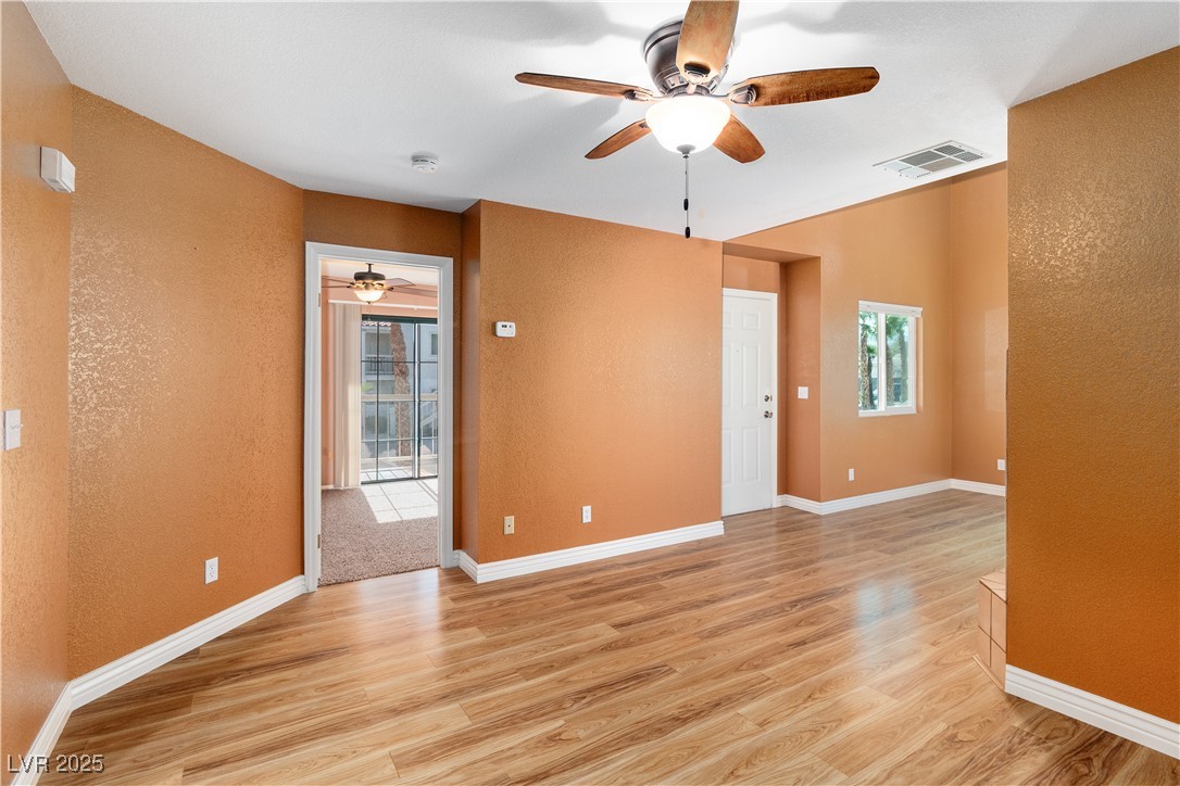 1948 Las Palmas Lane, Unit 277 Laughlin, NV 89029 - Photo 10 of 71 Dining area featuring a ceiling fan, light wood-style flooring, a textured wall, and a smoke detector